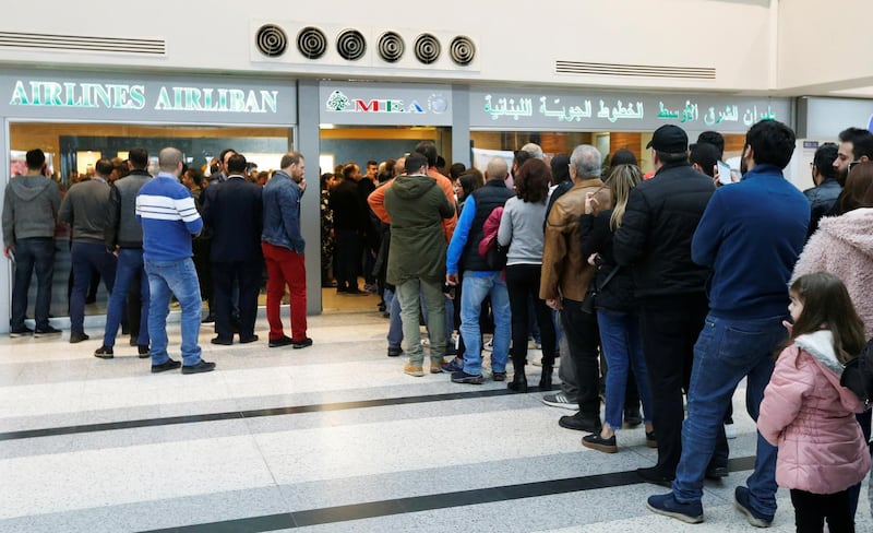 People queue to buy flight tickets at the Lebanese Middle East Airlines offices in Beirut international airport on Feburary 16. Reuters