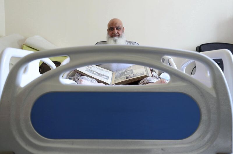 ABU DHABI,  UNITED ARAB EMIRATES , JUNE 17 – 2019 :- Mohammed Ishaq a player in the UAE's 1996 World Cup side, who is now wheelchair bound showing newspapers clipping at his home in Abu Dhabi. He is on wheelchair since a car crash in 2009. ( Pawan Singh / The National ) For Sport. Story by Paul