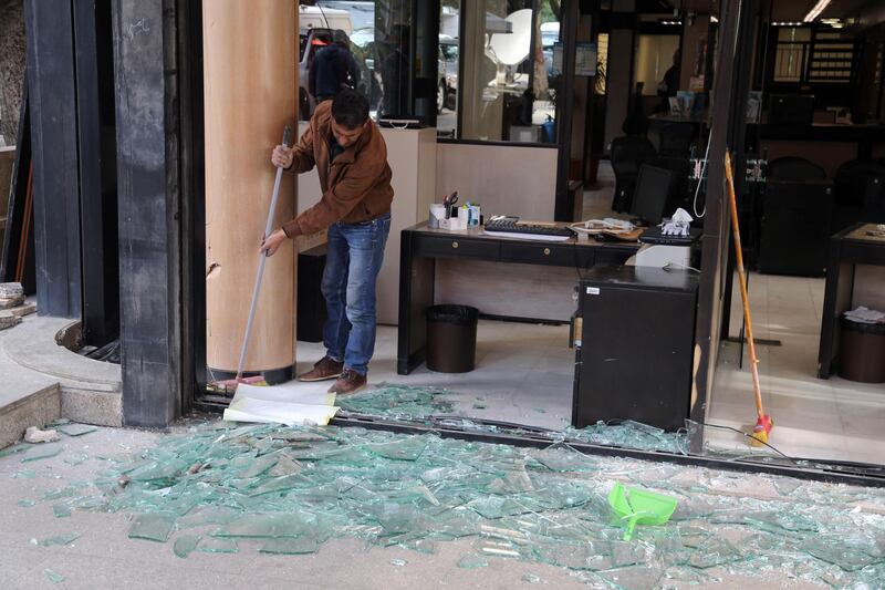 A worker clears up the shattered glass windows of a local Credit Libanais SAL bank branch on Hamra Street in Beirut, Lebanon, on Wednesday, Jan. 15, 2020. Lebanese protesters spilled back into the streets on Tuesday after a brief letup, blocking major highways as they denounced the lack of a functioning government at a time of deepening financial and economic crisis. Photographer: Hasan Shaaban/Bloomberg
