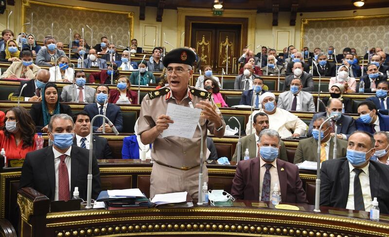 epa08557074 Egyptian General Mamdoh Shahen (2-L) holds up handwritten notes as he speaks during a parliamentary debate session to discuss and vote whether Egypt should send troops to the neighboring civil-war-torn nation of Libya, in Cairo, Egypt, 20 July 2020. According to media reports, the motion passed as the unicameral legislative body effectively rubber-stamped this foreign military deployment.  EPA/KHALED MASHAAL