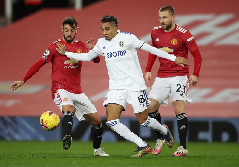 Manchester United's Bruno Fernandes and Luke Shaw in action with Leeds United's Raphinha. Reuters
