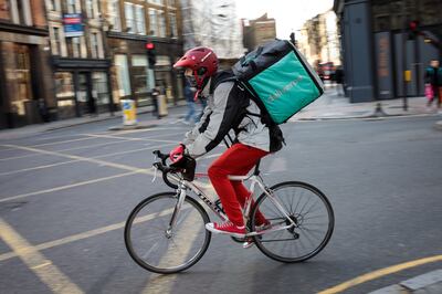 LONDON, ENGLAND - FEBRUARY 16: A Deliveroo rider cycles through central London on February 16, 2018 in London, England. Millions of part-time and flexible workers in the so-called gig economy are to receive new rights including sick and holiday pay under a new government reform. (Photo by Jack Taylor/Getty Images)