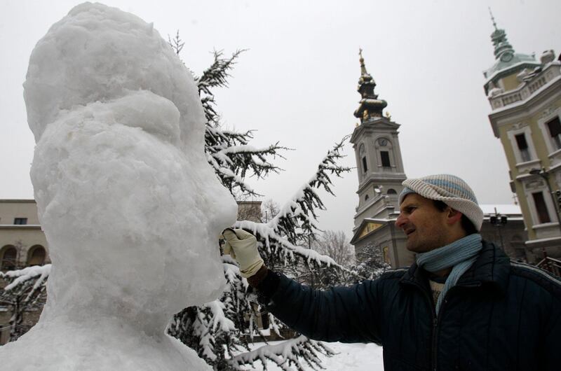 Sculptor Nenad Vuckovic puts the finishing touches to his snow sculpture, in Belgrade, Serbia, Sunday, Feb. 5, 2012. Freezing weather is affecting huge areas of Europe disrupting traffic. (AP Photo/Darko Vojinovic) *** Local Caption ***  Serbia Europe Weather.JPEG-07730.jpg