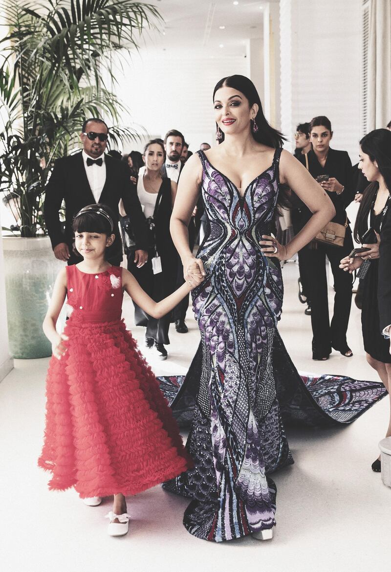 This picture shows Aishwarya and her daughter Aaradhya en route to the red carpet. Getty