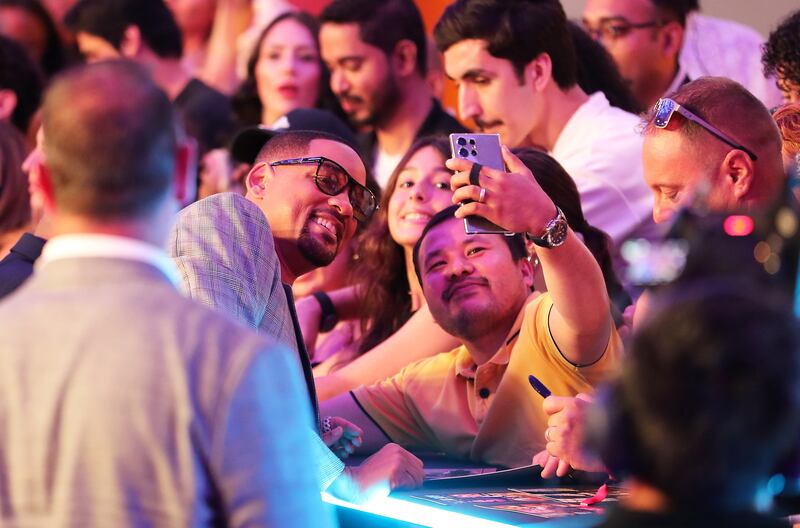 A fan takes a selfie with Will Smith outside the Coca-Cola Arena in Dubai