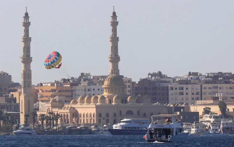 Tourists parasail over the sea in front of the Port Grand Mosque during a summer vacation on the Orange beach at a Red Sea resort, amid the coronavirus disease (COVID-19) pandemic, in Hurghada, Egypt August 25, 2020. REUTERS/Amr Abdallah Dalsh