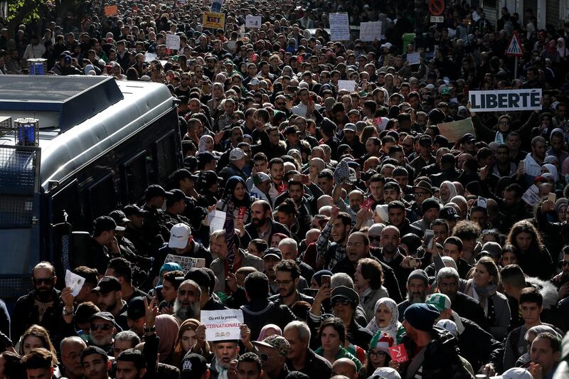 Algerian students march, one with a poster reading "Freedom", right, during a protest in Algiers. AP Photo