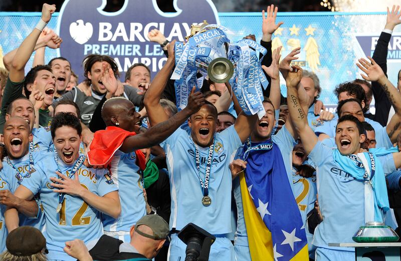 Manchester City captain Vincent Kompany lifts the Premier League trophy after their dramatic win over Queens Park Rangers at the Etihad Stadium on May 13, 2012. Getty