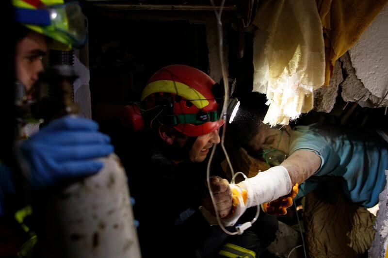 Firefighters rescue a survivor after an earthquake hit Thumane, Albania. EPA