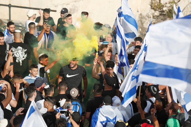 Marchers carry Israeli flags. EPA