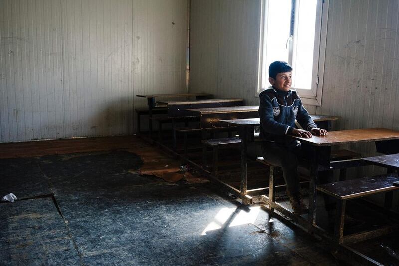 An Iraqi boy sits at a desk at a school in Mosul's eastern Gogjali neighbourhood on January 23, 2017, as scores of schools resumed their activities in the areas government forces recently recaptured from ISIL during the government's ongoing military operation against the extremists. Dimitar Dilkoff/AFP