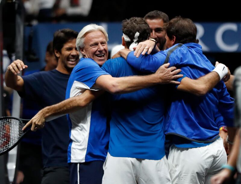 Europe's Roger Federer, center, celebrates with teammates and team's captain Bjorn Borg, left, after defeating World's Nick Kyrgios during their Laver Cup tennis match in Prague, Czech Republic, Sunday, Sept. 24, 2017. (AP Photo/Petr David Josek)