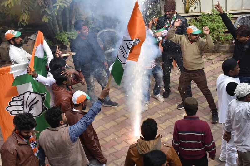 Congress-JMM alliance workers celebrate results projecting an assembly majority in the Jharkhand state election in Ranchi on December 23, 2019. / AFP / Rajesh Kumar
