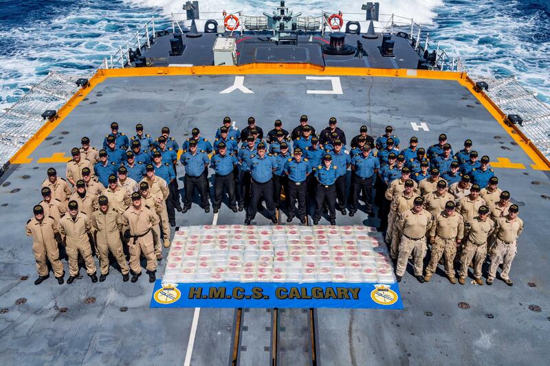 Members of HMCS CALGARY stand with 195 kg of methamphetamine seized from a dhow during a counter-smuggling operation on 24 April, 2021 in the Arabian Sea during OPERATION ARTEMIS and as part of Combined Task Force 150.

Please credit: Corporal Lynette Ai Dang, Her Majesty's Canadian Ship CALGARY, Imagery Technician
©2021 DND/MDN CANADA