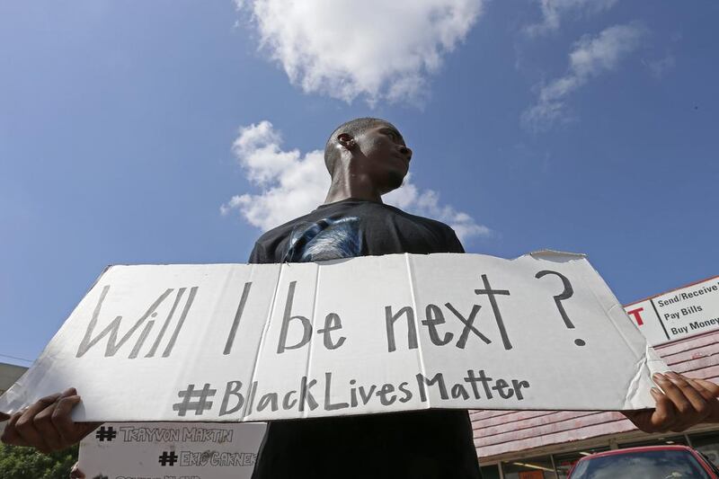 A protester holds a sign at a Black Lives Matter protest in Dallas. Jae S. Lee / The Dallas Morning News via AP