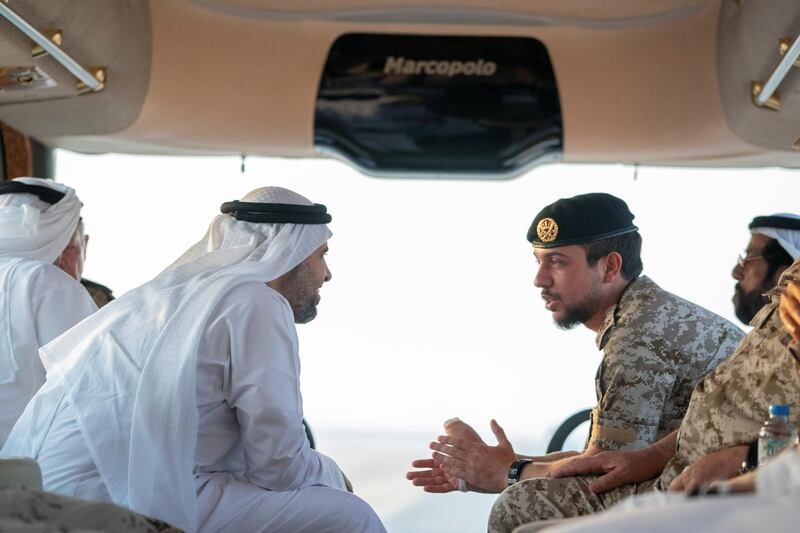 AL DHAFRA REGION, ABU DHABI, UNITED ARAB EMIRATES - June 26, 2019: HH Sheikh Theyab bin Mohamed bin Zayed Al Nahyan, Chairman of the Department of Transport, and Abu Dhabi Executive Council Member (L) and HRH Hussein bin Abdullah, Crown Prince of Jordan (R), inspect military exercise sites during the UAE and Jordan joint military drill, Titled ‘Bonds of Strength’, at Al Hamra Camp.

( Mohamed Al Hammadi / Ministry of Presidential Affairs )
---