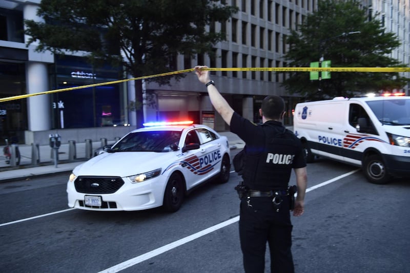 Police activity at the entrance to Pennsylvania Avenue near the White House shortly after Secret Service guards shot a person who was apparently armed, outside the White House.  AFP
