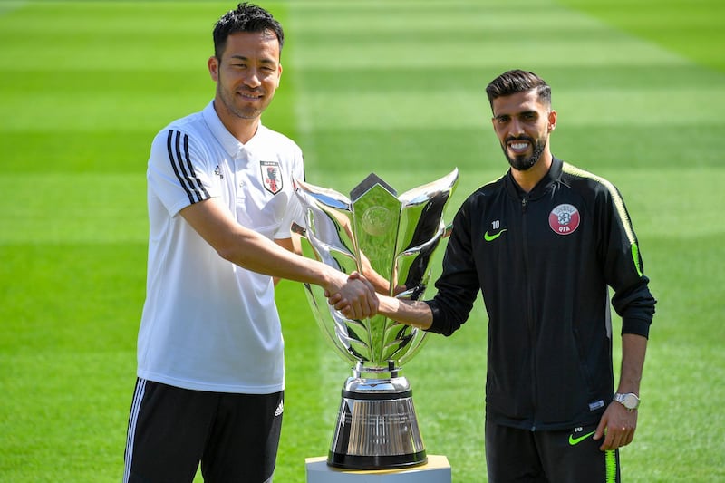 Maya Yoshida of Japan and Hasan Al Haydos poses for photographs with Asian Cup trophy at Zayed Sports City Stadium in Abu Dhabi, United Arab Emirates. Getty Images