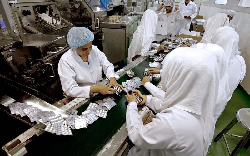 Ras al Khaimah - June 30, 2010 - Operators handle pages of five hundred milligram tablets of the Type 1 Diabetes medicine Dialon along the conver belt of this packing machine in Gulf Pharmaceuticals Julphar in Ras al Khaimah, June 30, 2010. (Photo by Jeff Topping/The National) 
 