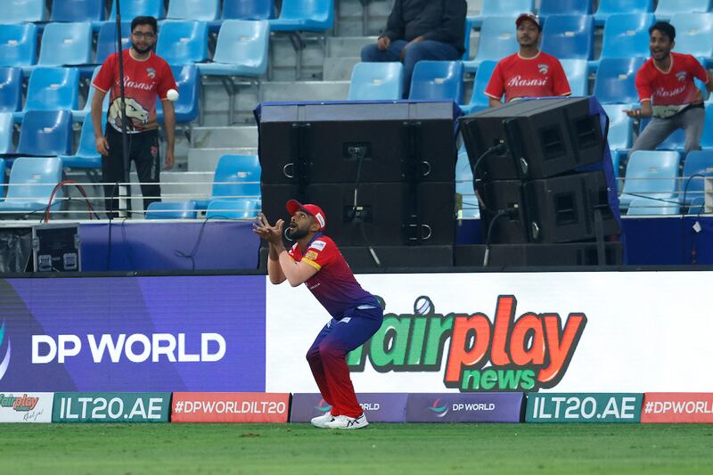 Dubai Capitals' Chamika Karunaratne takes a catch to dismiss Rohan Mustafa of Desert Vipers.