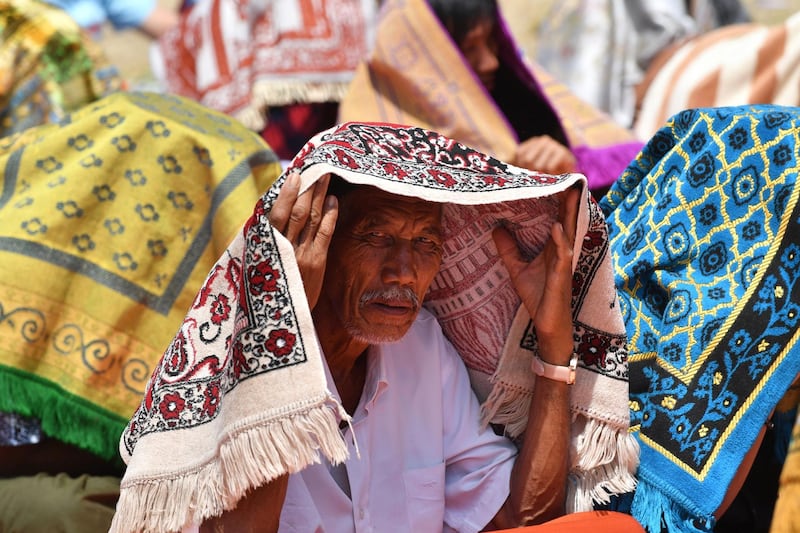 An Indonesian man arrives for Friday prayers on a field near temporary shelters in Pemenang, northern Lombok. AFP