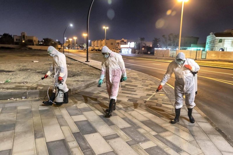 SHARJAH, UNITED ARAB EMIRATES. 26 MARCH 2020. Sharjah Municipal staff spray and disinfect the sidewalk along the Al Muntazah Str area of Sharjah near the Ajman border. . (Photo: Antonie Robertson/The National) Journalist: None. Section: National.