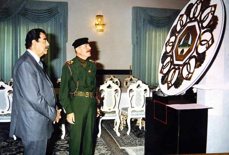 Saddam Hussein, left, and his right-hand man Izzat Ibrahim Al Douri while looking at artwork depicting Jerusalem's Dome of the Rock, in Iraq's capital Baghdad, in 2002. AFP
