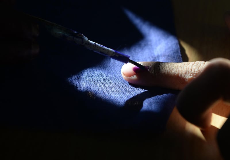 (FILES) In this file photo taken on April 18, 2019 an Indian voter gets his finger marked with ink as he votes at a polling station in Chennai, during the second phase of the mammoth Indian elections. An Indian man has chopped off his index finger in desperation after voting for the wrong party in the country's national election. / AFP / ARUN SANKAR
