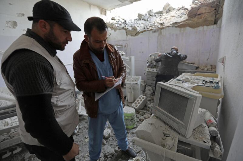 Syrian medics check the damage at the "Sham Surgical" hospital, one of several hospitals targeted by air strikes in Idlib province over the past few days, after it was hit in the middle of the night, in the northwestern town of Hass on February 15, 2018. (Photo by OMAR HAJ KADOUR / AFP)