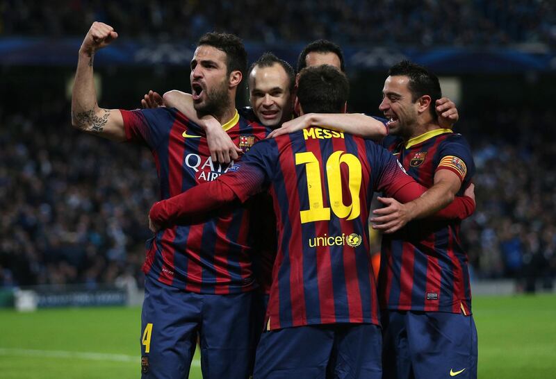 MANCHESTER, ENGLAND - FEBRUARY 18:  Lionel Messi of Barcelona celebrates scoring the opening goal from a penalty kick with his team-mates during the UEFA Champions League Round of 16 first leg match between Manchester City and Barcelona at the Etihad Stadium on February 18, 2014 in Manchester, England.  (Photo by Clive Brunskill/Getty Images)