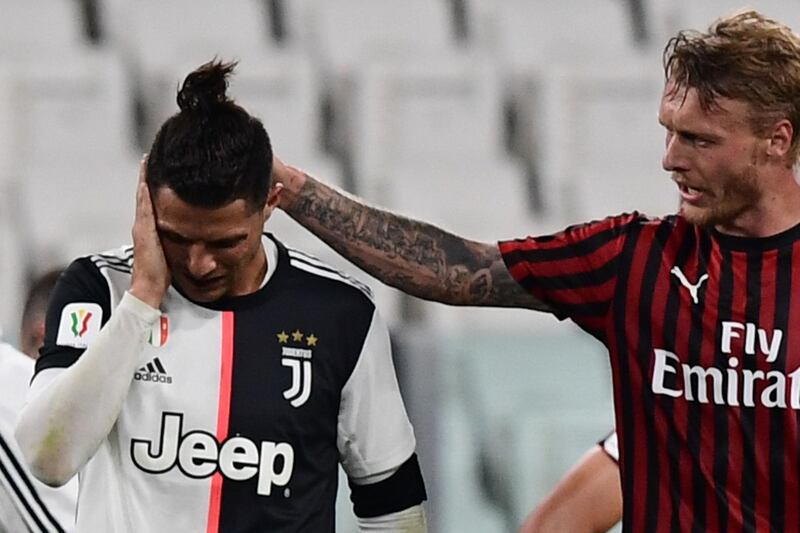 AC Milan's Danish defender Simon Kjaer comforts Cristiano Ronaldo after they collided. AFP