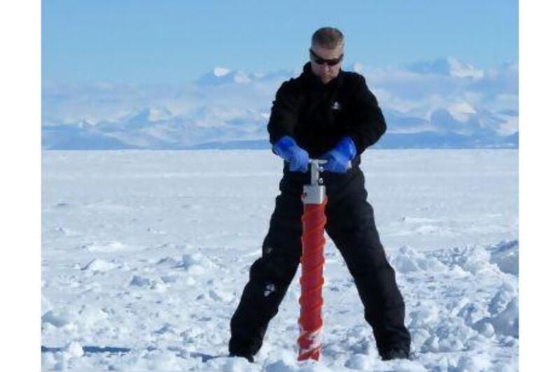 Professor Kenneth Golden takes a sample from an ice sheet in Antarctica. Courtesy of Kenneth Golden