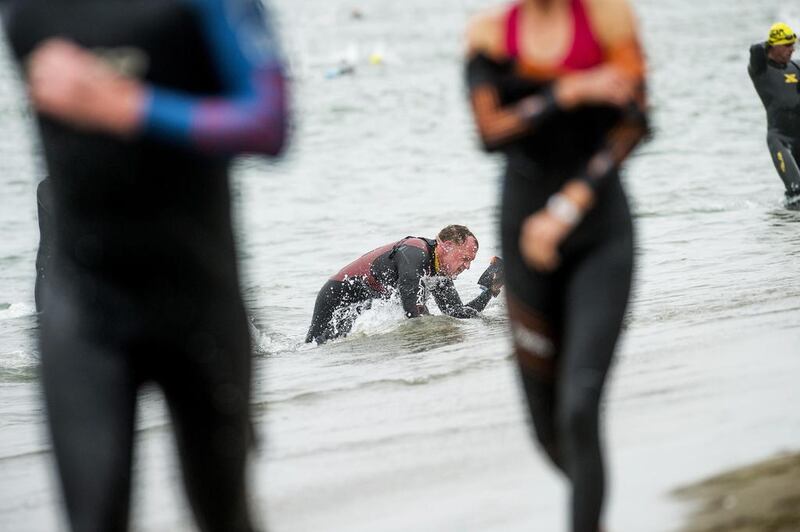 A triathlete struggles to stand after the swim portion of the Escape from Alcatraz Triathlon in San Francisco, California on Sunday. Noah Berger / Reuters / June 1, 2014