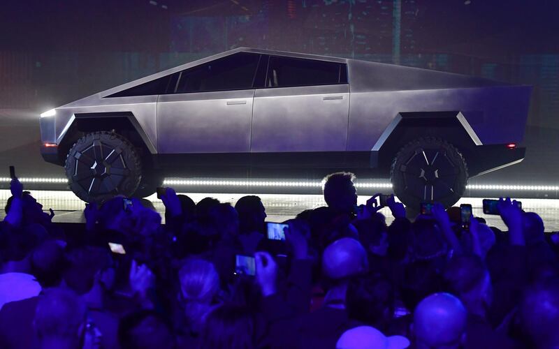 People take pictures of the newly unveiled all-electric battery-powered Tesla's Cybertruck at Tesla Design Center in Hawthorne, California on November 21, 2019.  / AFP / FREDERIC J. BROWN
