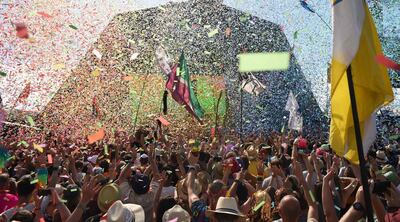 (FILES) In this file photo taken on June 30, 2019, revellers cheer as Australian singer Kylie performs at the Glastonbury Festival of Music and Performing Arts on Worthy Farm near the village of Pilton in Somerset, South West England. Britain's Glastonbury Festival has announced a livestreamed concert in May at its famous southwest English farm site, after the pandemic led to the blockbuster event's cancellation for the second consecutive summer. - 
 / AFP / Oli SCARFF                          
