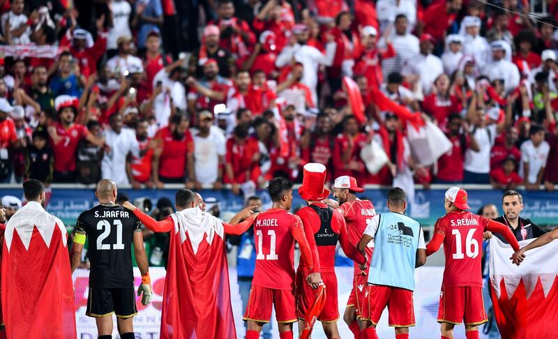 Bahrain players celebrate in front of supporters. EPA