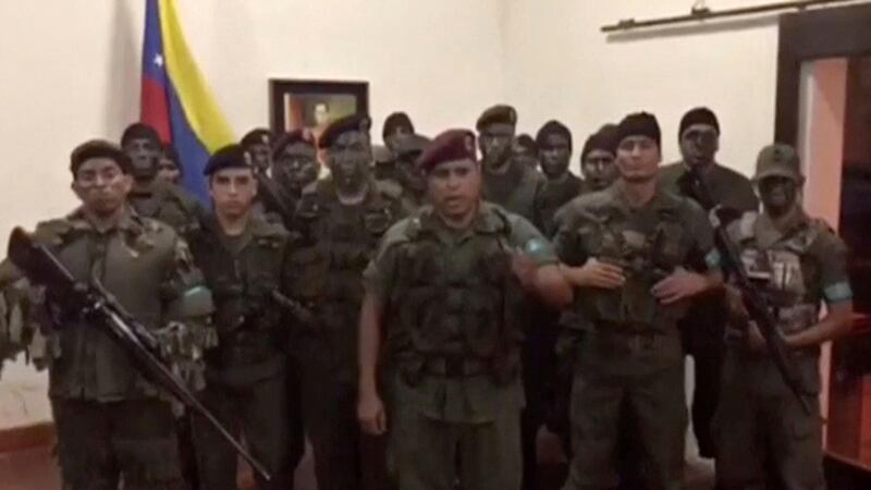 A still image from a video released showing uniformed men announcing an uprising at the military base in Valencia. Credit: Reuters