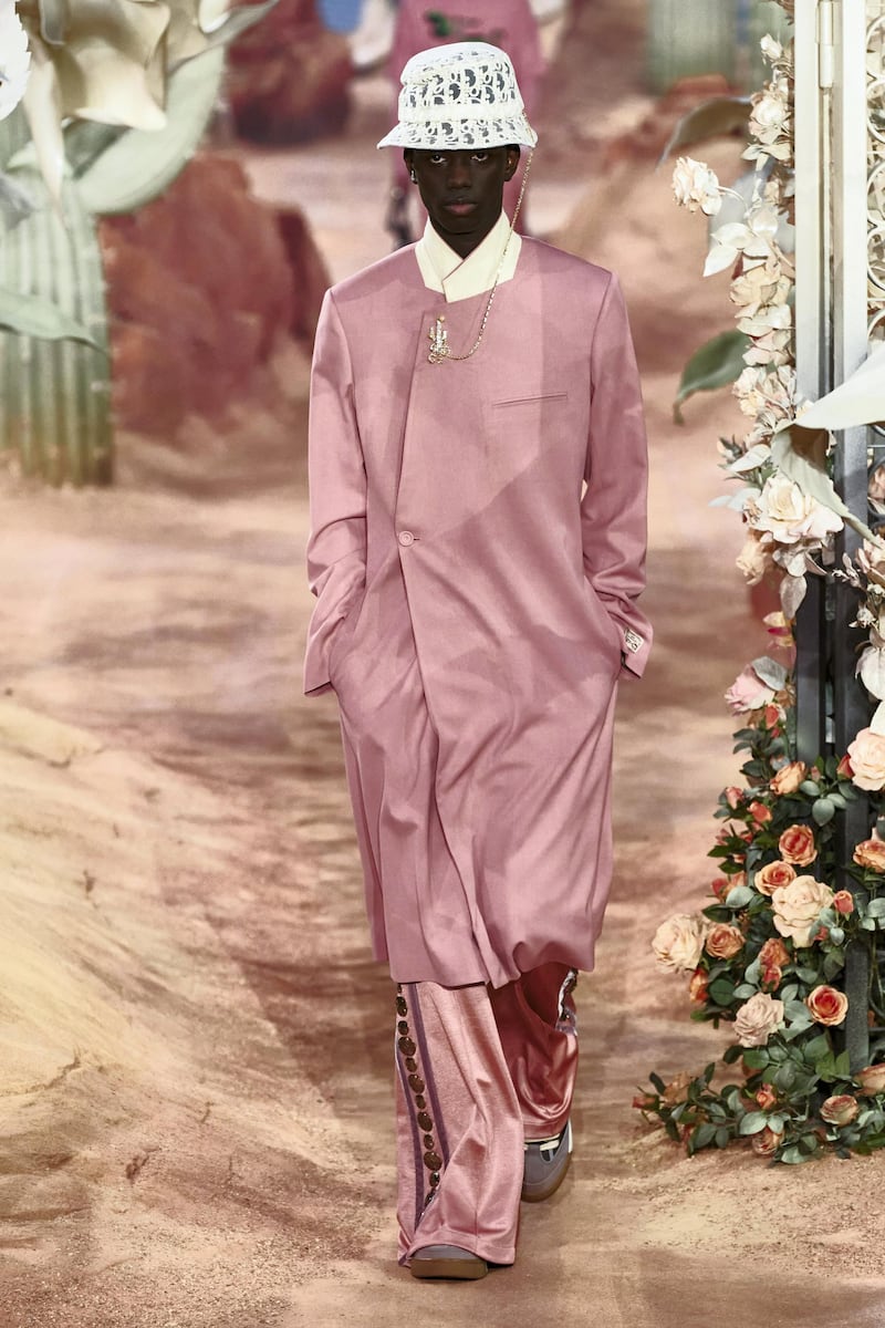 At Dior, a mottled dusty pink coat is made double breasted, while trousers have cowboy-style medallions up the sides. Courtesy Dior