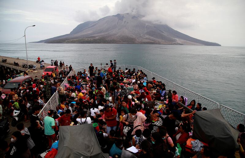 People board KRI Kakap-881 warship in the port of Tagulandang, to be evacuated to North Minahasa Regency on Sulawesi island, following the eruptions of Mount Ruang volcano in Sitaro, Indonesia. Reuters