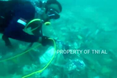 Video footage released by the Indonesian Navy shows divers recovering debris from the Sriwijaya Air passenger jet, which crashed in the Java Sea on January 9. AP