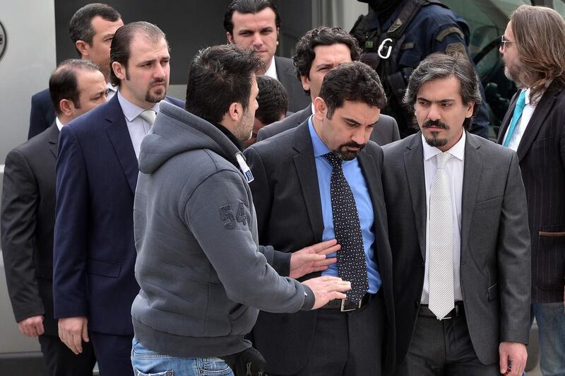 Eight Turkish army officers are escorted by Greek police as they arrive at the supreme court on January 26, 2017. Louisa Gouliamaki /AFP