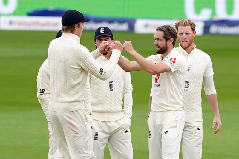 England's Chris Woakes celebrates with teammates after taking the wicket of West Indies' Shane Dowrich duringthe final day of the second Test in Manchester. AFP