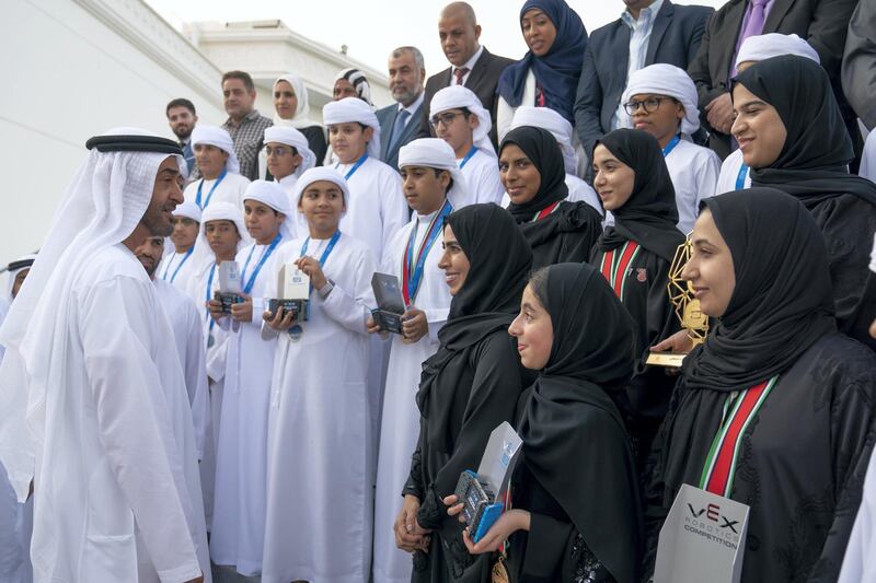 ABU DHABI, UNITED ARAB EMIRATES - June 24, 2019: HH Sheikh Mohamed bin Zayed Al Nahyan Crown Prince of Abu Dhabi Deputy Supreme Commander of the UAE Armed Forces (L), speaks with The UAE School students who won the second place in the World Championship of Artificial Intelligence and Robot Fix, which was held in Kentucky, USA, during a Sea Palace barza.

( Hamad Al Kaabi  / Ministry of Presidential Affairs )
---