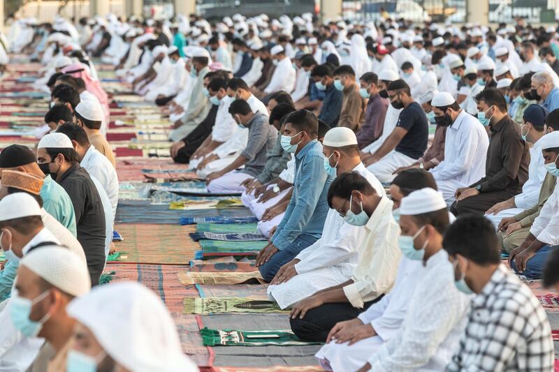 Worshippers attend the Eid prayers at the Umm Suquim Eid prayer grounds. Antonie Robertson / The National