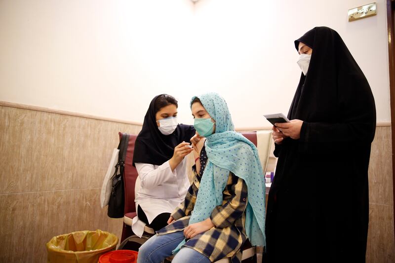 An Iranian student receives a Covid-19 vaccine at a school in Tehran after authorities started vaccinations of 12 to 18-year-olds following criticism of the country's efforts to counter the coronavirus. EPA