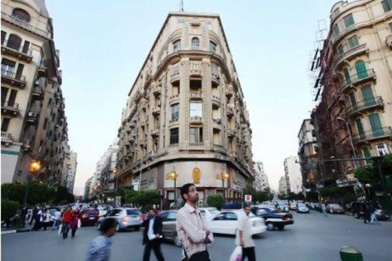 Pedestrians pass through Talat Harb square in downtown Cairo, Egypt. Shawn Baldwin/Bloomberg