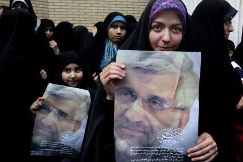 Iranian women hold posters of presidential candidate Saeed Jalili, the country's top nuclear negotiator, at a campaign rally for his female supporters in Tehran.