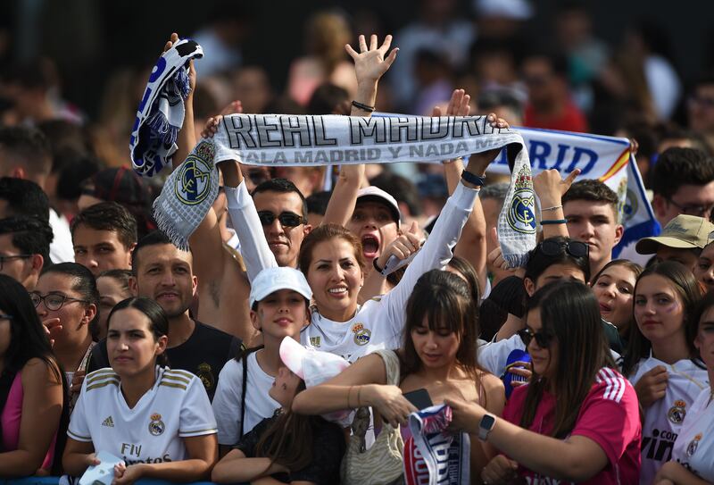 Real Madrid supporters celebrate at Cibeles square while awaiting their team's arrival. Getty