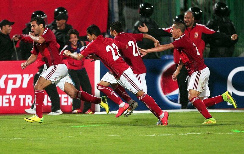 Al Ahly player Emad Meteb, left, celebrates scoring winner with teammates in the CAF Confederation Cup final in Cairo on Saturday. Khaled El Fiqi / EPA