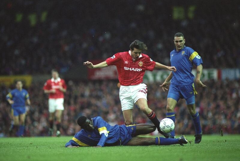 31 Oct 1992:  Robbie Earle of Wimbledon slides in to tackle Darren Ferguson of Manchester United during an FA Carling Premier League match at Old Trafford in Manchester, England. Wimbledon won the match 1-0. \ Mandatory Credit: Gary M Prior/Allsport